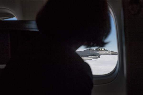 President Tsai looks out of the window at the four F-16 and two IDF fighter jets accompanying her plane.